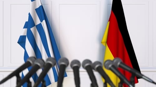Flags of Greece and Germany Waving at Press Conference