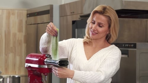 Woman Making Homemade Pasta in a Kitchen