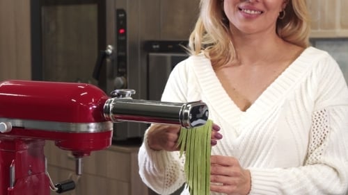 Woman Making Pasta with a Pasta Machine