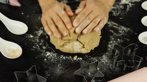 Hands Kneading Cookie Dough with Baking Utensils