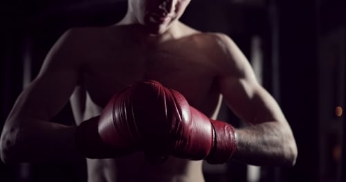 Close Up of Shirtless Boxer with Red Gloves