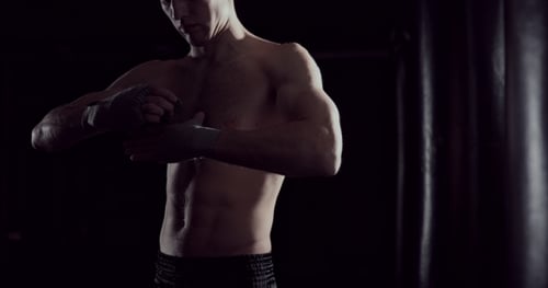 Muscular Man Wrapping His Hands for Boxing