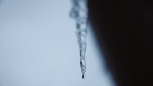 Long Sharp Icicle Hanging on Roof