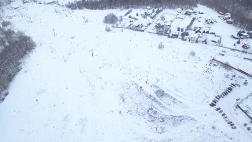 Aerial View People Skiing and Snowboarding on Ski Slope on Winter Ski Resort