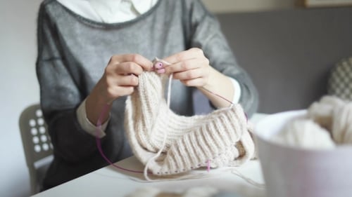 Woman Knitting Handmade Woolen Garment at Home