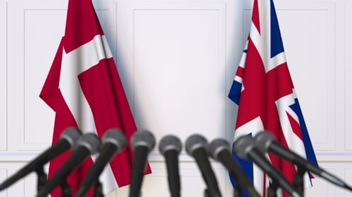 Denmark and United Kingdom Flags at Press Conference Background