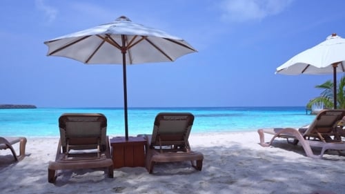 White Sun Umbrellas and Beds at Seaside