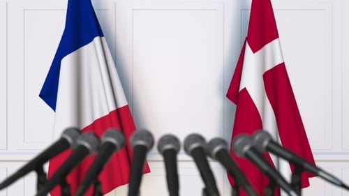 French And Danish Flags Waving At Press Conference