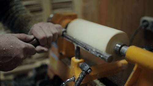 Craftsman Using a Lathe to Shape Wood