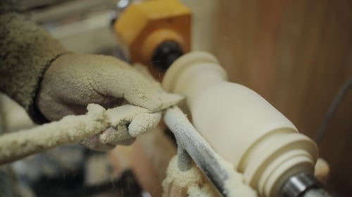 Woodworker Shaping Wood on a Lathe Machine