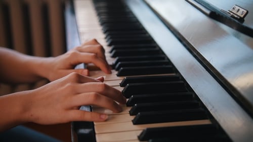 Close Up Hands Playing Piano Keys