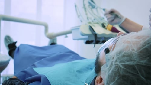 Dentist at Work in the Office A Female Doctor Examines the Teeth and Jaws of a Male Patient