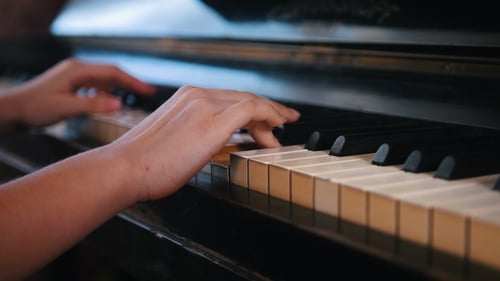 Hands Playing Piano Keys Close Up