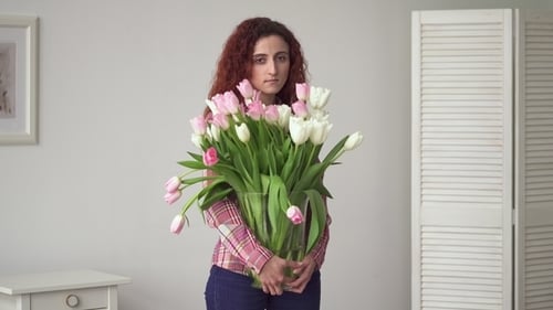 Woman Holding Vase with Large Bouquet of Tulips