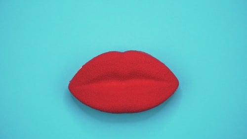 Bright and Colorful Cake Red Lips on a Blue Background. Rotating Top View.