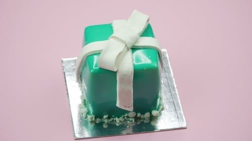 Delicious Present Cake on Pink Background Rotating