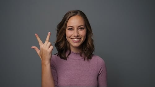 Cheerful Woman Counting to Five on Fingers