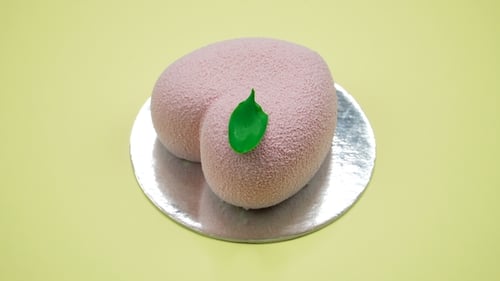 Bright and Colorful Cake Heart on a Yellow Background. Rotating Top View.