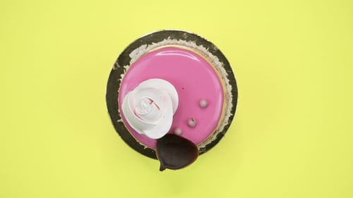 Bright and Colorful Cake on a Yellow Background. Rotating Top View.