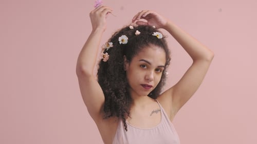 Pretty Young Woman in Studio with Flowers in Head