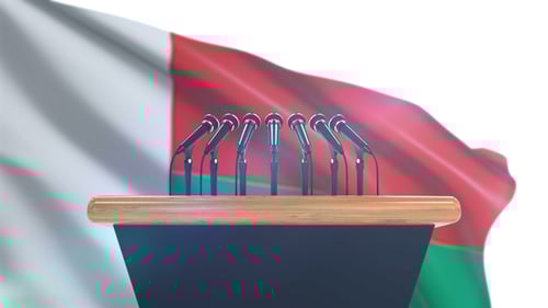 Press Conference Podium with Waving Flag Background