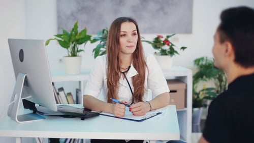 Doctor Consults with Patient in Office Setting