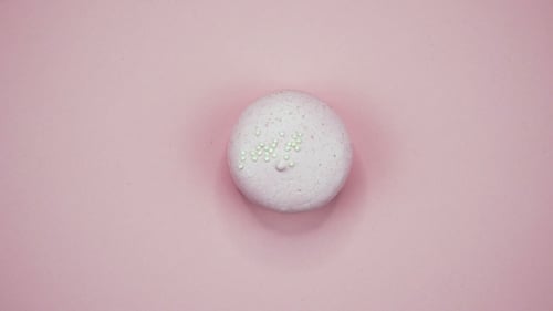 Pastel Macaron Dessert with Sprinkles on Pink Surface