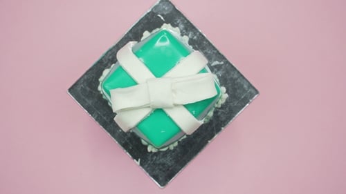 Gift Cake Decorated on Pink Surface Overhead