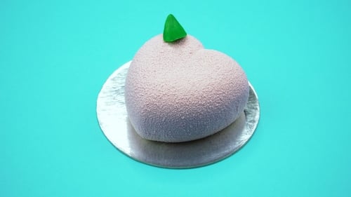 Bright and Colorful Cake Heart on a Blue Background. Rotating Top View.