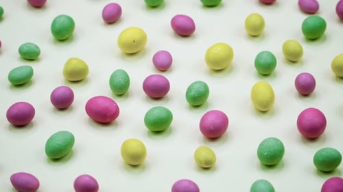 Video of Tasty Crispy Round Candies Isolated on White Background. Yellow, Orange, Green, Pink and