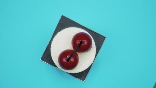 Delicious Cake Topped with Cherries on Blue Background