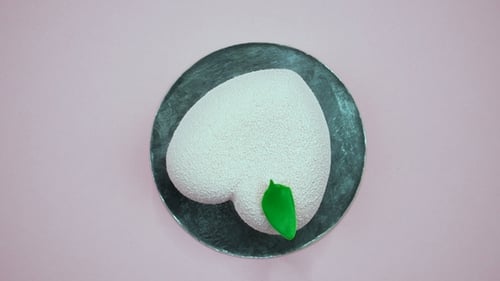 Bright and Colorful Cake Heart on a Pink Background. Rotating Top View.