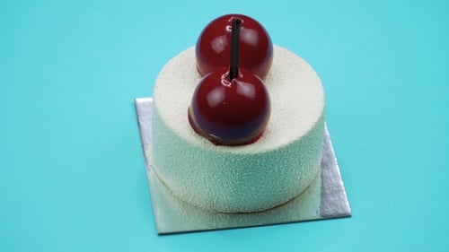 Bright and Colorful Cake on a Blue Background. Rotating Top View.