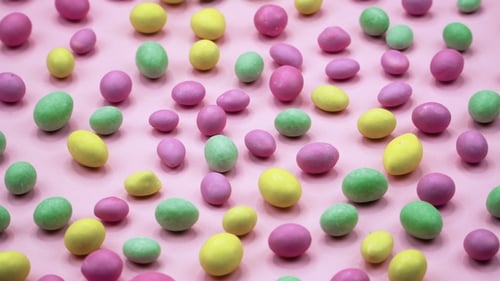Video of Tasty Crispy Round Candies Isolated on Pink Background