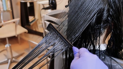 Close-up Combing Wet Hair at Beauty Salon