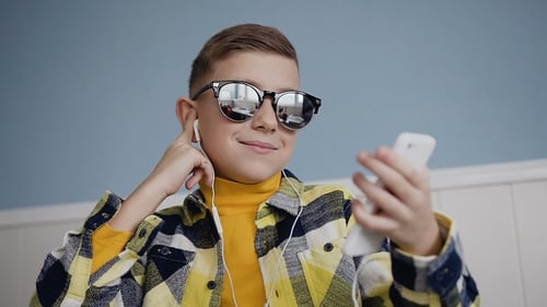 Happy Child Listening to Music on Smartphone