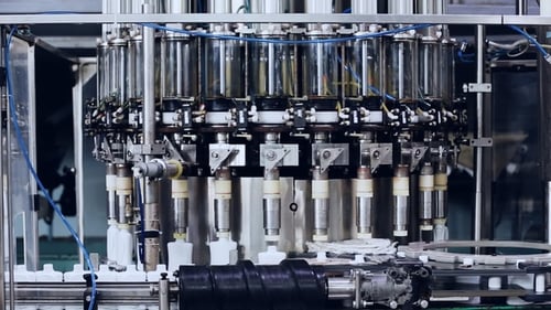 Automated Machinery Filling White Bottles