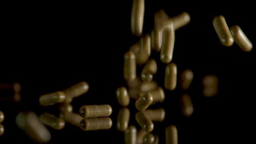 Pill Capsules Falling on the Mirror Table