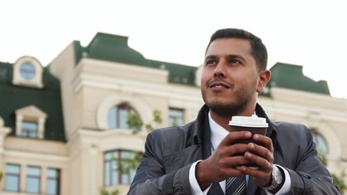 Man Holding Coffee Cup In The City