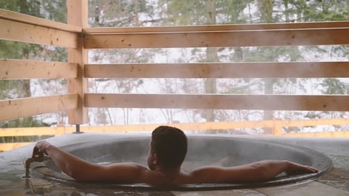 Man Relaxing in Hot Tub in Winter