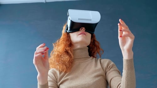 Woman Experiencing Virtual Reality with Headset Indoors