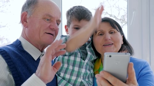 Grandparents and Child Video Call on Smartphone