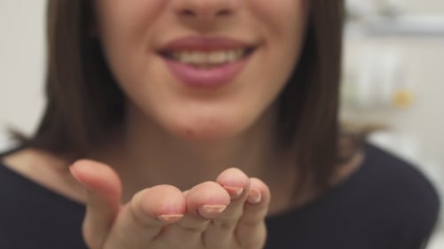 Woman Smiling and Blowing a Kiss Close Up