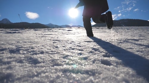 Unrecognizable Guy Jogging on Snowy Field at Sunny Winter Day Young Man Running on Snowy Meadow