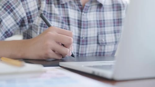 Designer Drawing on Graphics Tablet with Digital Pen