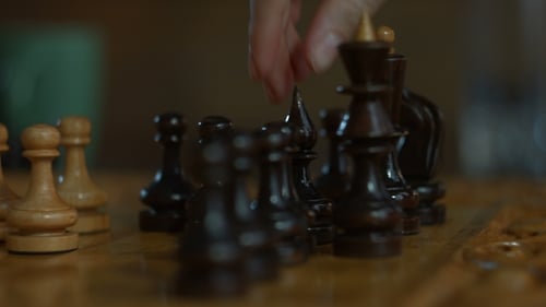 Hand Moving Chess Pieces on Board Close Up