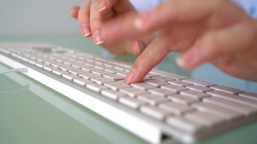Woman Office Worker Typing on the Keyboard