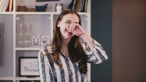 Smiling Woman in Striped Blouse Indoors