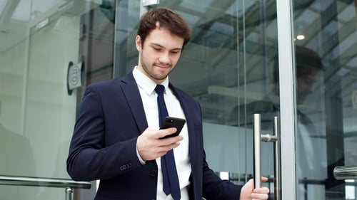 Handsome Businessman Using Smartphone in The Office.