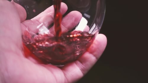 Pouring Red Wine into a Glass